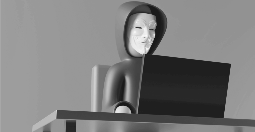 This image of a masked model at a computer illustrates our discussion topic: Agentic AI, the relevance of autonomous phishing for modern businesses, and how to tackle it with Digital Risk Protection.