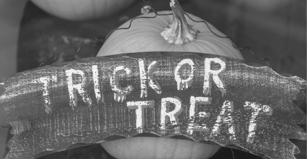This image of a pumpkins wiht a sign saying "trick or treat' illustrates our discussiont topic: Bionic infringers, and keeping brands safe from cyberattacks during spooky season.