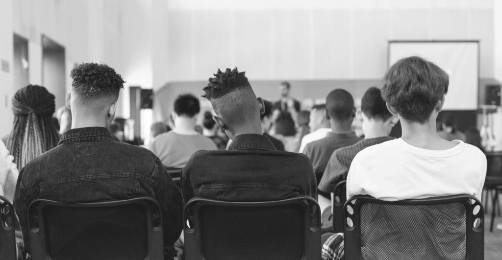 This image of school kids in an assembly room illustrates our discussion topic: Back to school scams.
