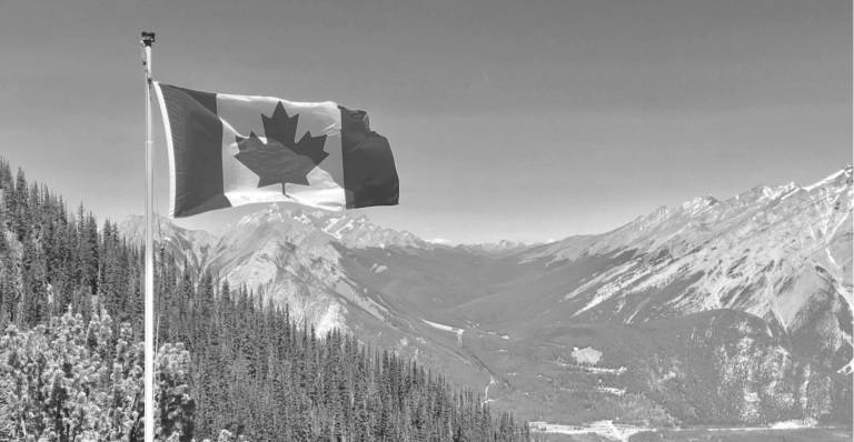 This image of the Canadian flag in front of a beautiful mountainous panorama highlights our discussion topic: counterfeiting and replicas in Canada, what brands can learn about them, and how to fight back.