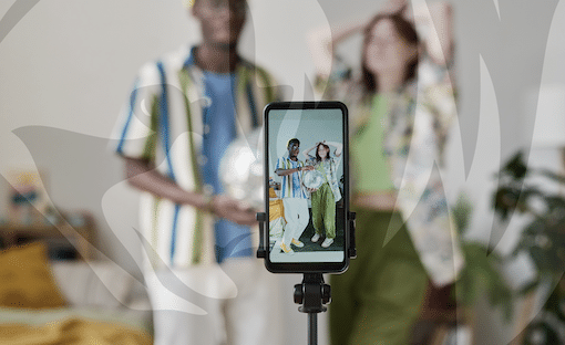 Influencers recording a video on a smartphone mounted on a tripod