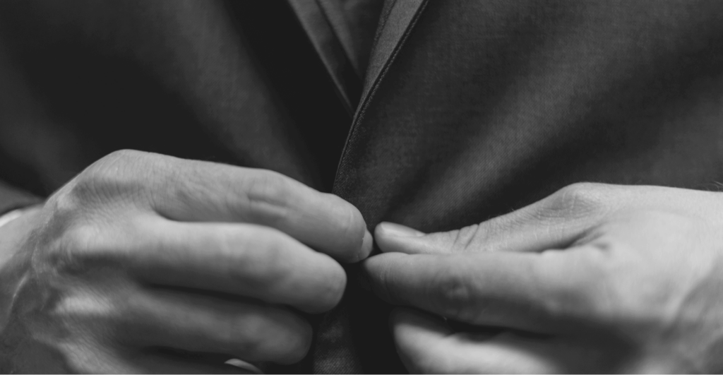 This image of someone buttoning up their suit jacket illustrates our discussion topic: CEO fraud, VIP and Executive protection, social media monitoring, social media scams, and malicious ads that target brands.