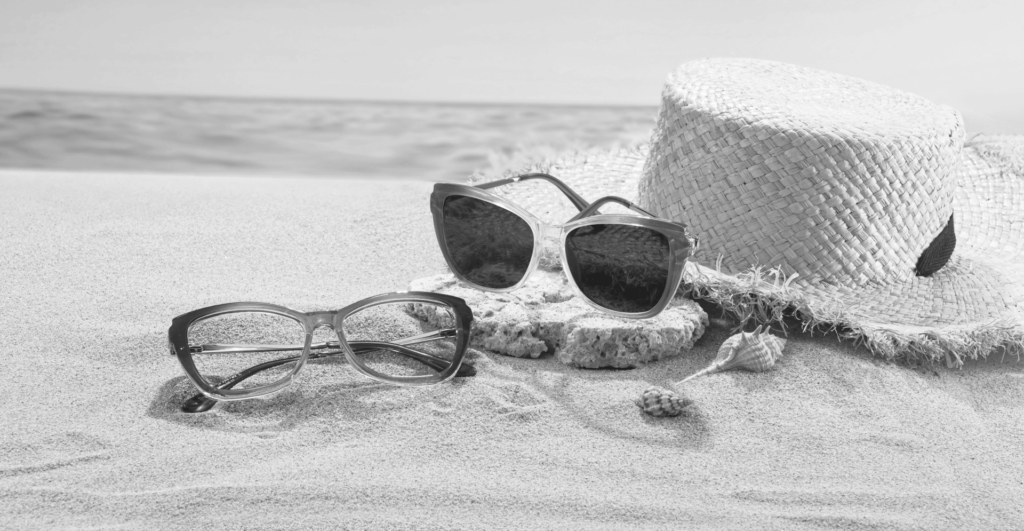 This image of sunglasses on sand illustrates our discussion topic: customer service scams in the travel and services industries.
