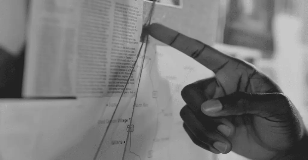 Hand pointing at a map, representing election-related cybersecurity strategy